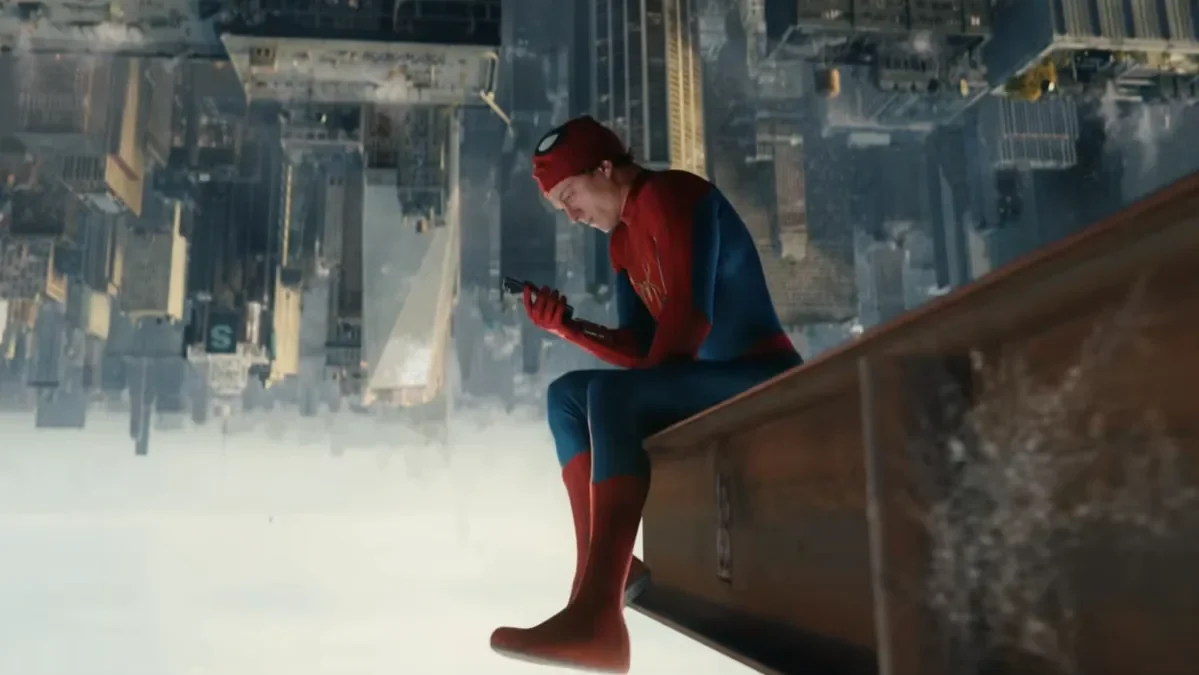 Spider-Man seated above an inverted cityscape