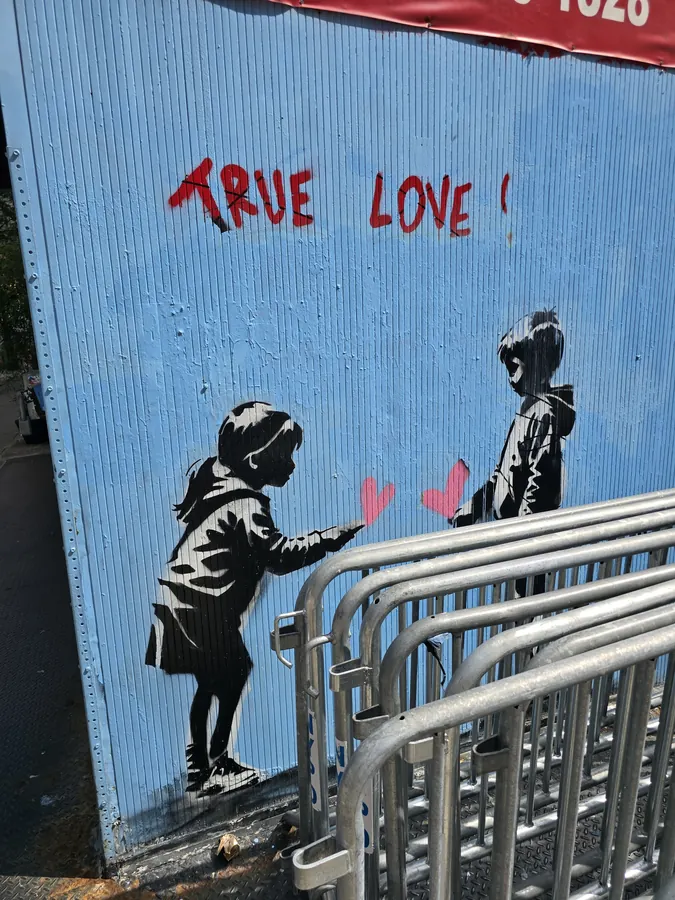 Street art reading True Love above a subway entrance